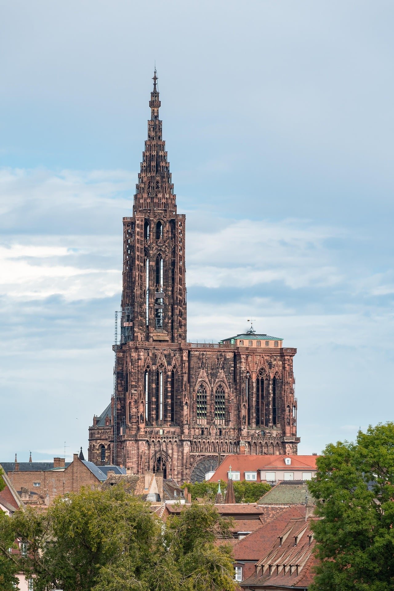 Straßburger Münster mit dem hohen Turm aus rotem Sandstein über den Dächern der Altstadt